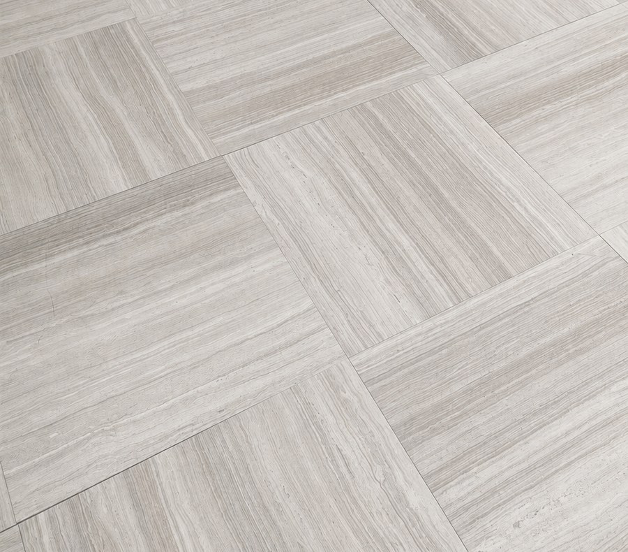 Close-up of White Wood Marble slab showing its natural wood-grain veining